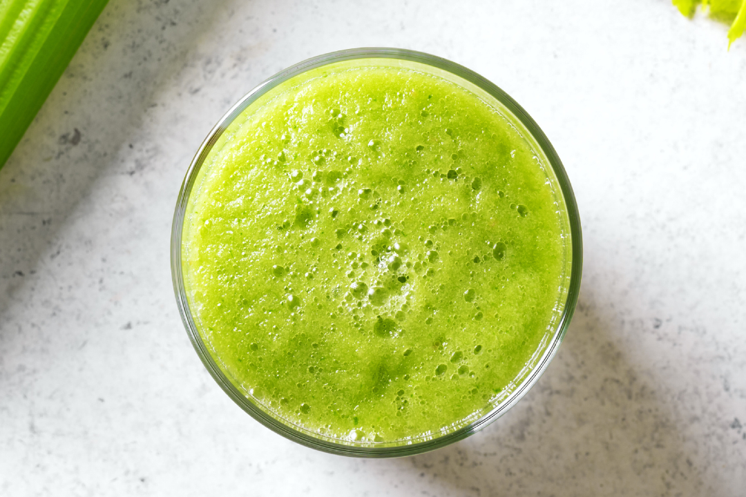 Bright green juice in a glass, symbolizing common detox myths debunked in our blog.