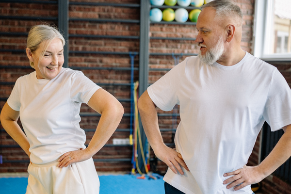 Older adults in a fitness class doing mobility exercises to improve movement, flexibility, and overall hip health.